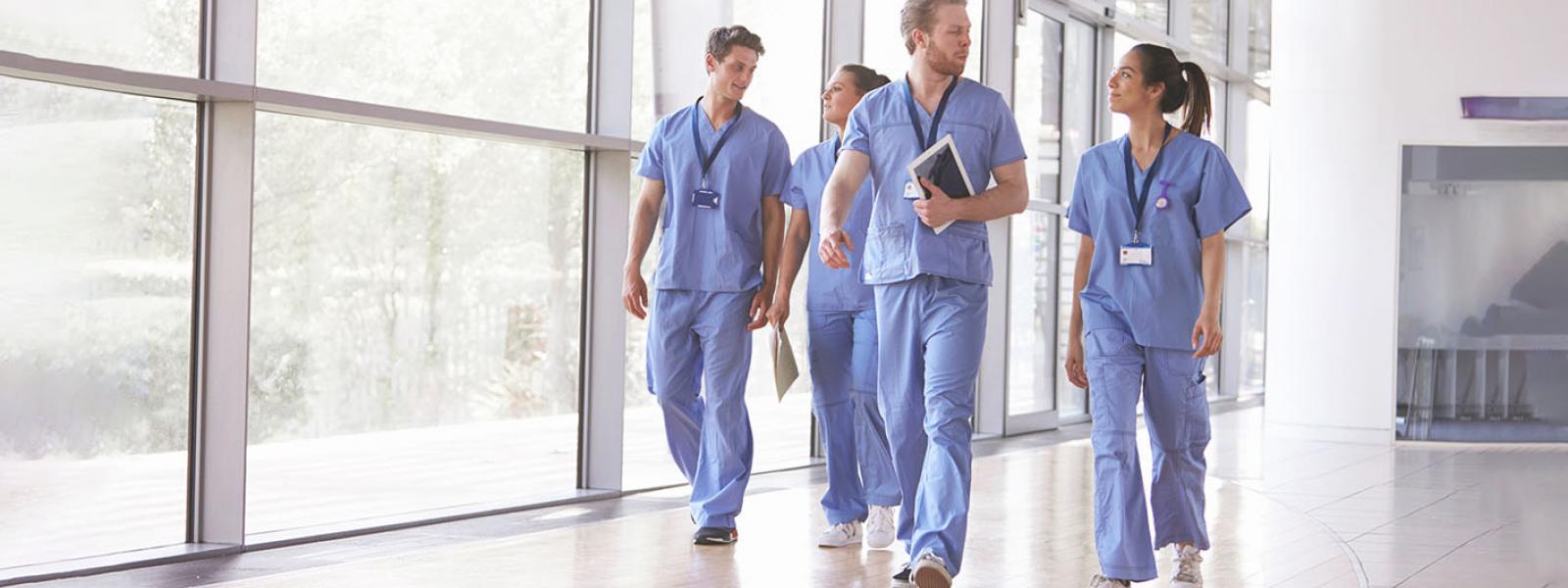 healthcare workers walking through hallway