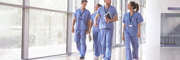 healthcare workers walking through hallway