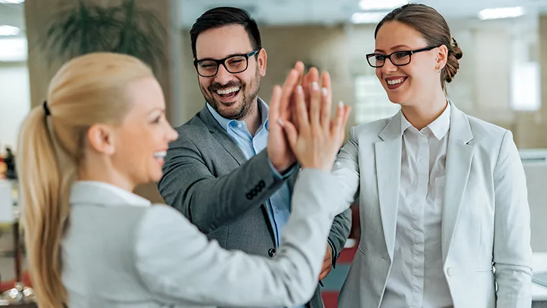 Happy team giving high five