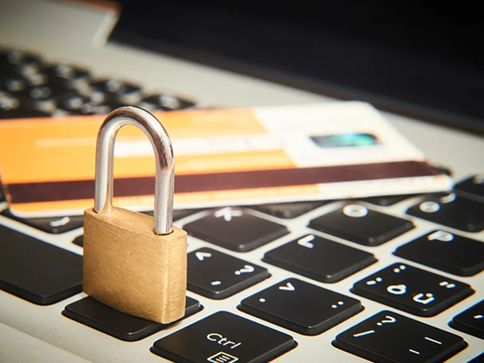 Credit card and padlock on laptop keyboard